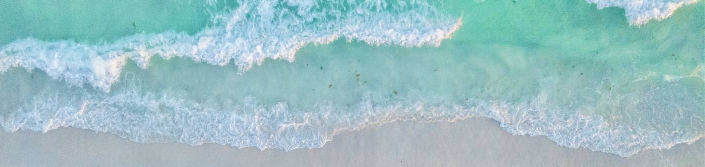 aerial view of ocean waves on shore